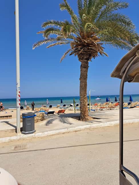 Crete: Malia, Potamos Beach, and Sissi Tuk Tuk Tour - Stalis on the way back: lively beach road energy