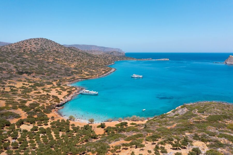 From Ag. Nikolaos: Spinalonga & Kolokytha Cruise with Lunch - Lunch on board in Cretan style: roasted pork, veg options, and realistic expectations