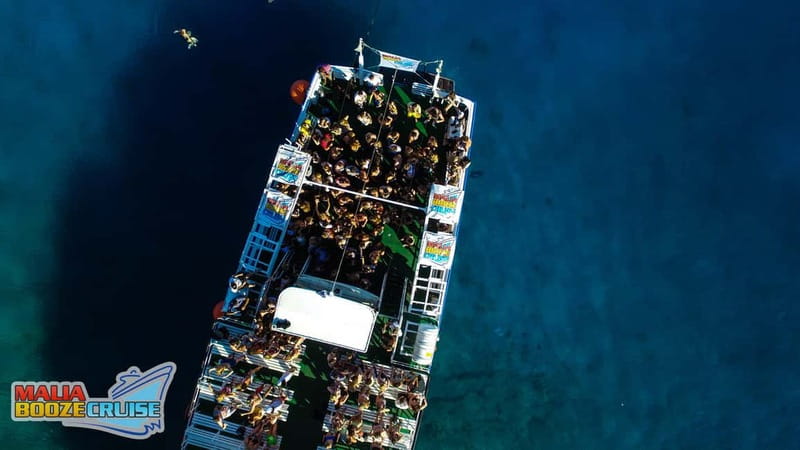Malia: Booze Cruise Boat Party with Live Dj - The 4-Hour Flow: Transfer, Port Time, Swim Bay, Sunset Return